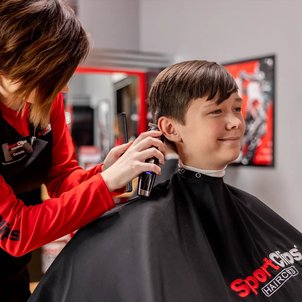 sport-clips-jr-varsity-haircut young boy getting a haircut